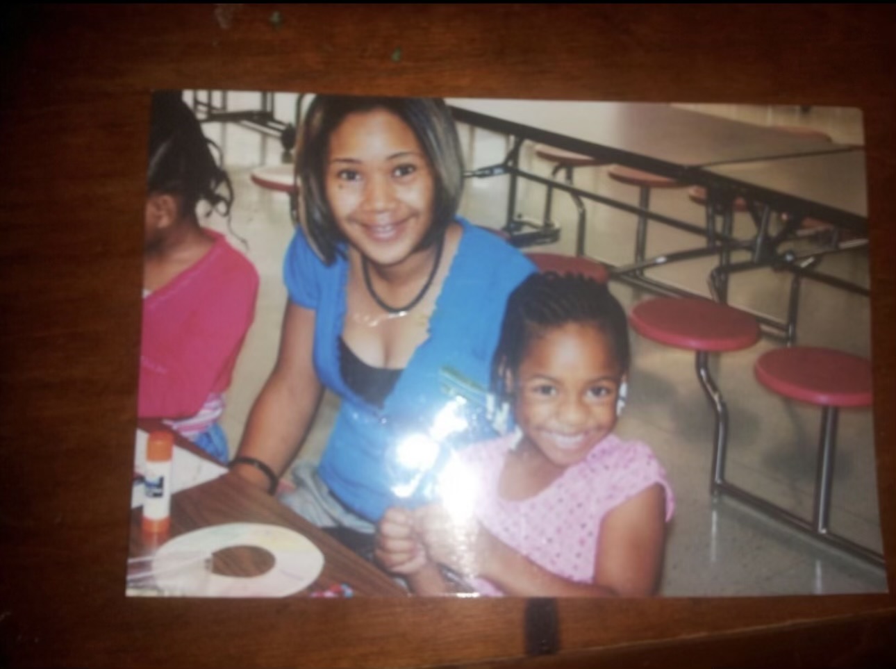 Laura Green smiling with a young student
